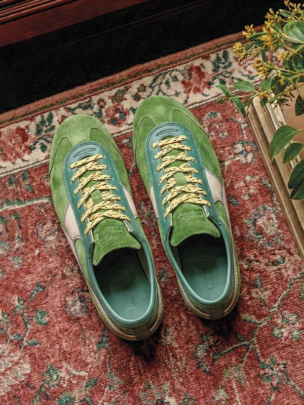 Olive-toned urban sneakers with suede cues and gum sole units