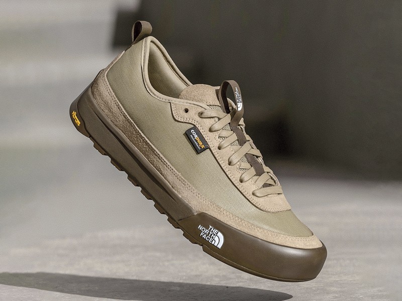 Olive-toned urban sneakers with suede cues and gum sole units