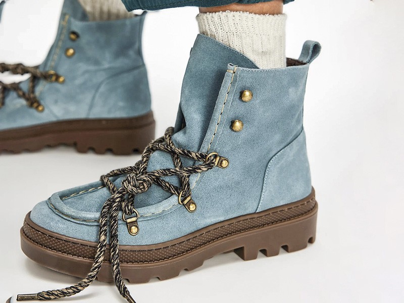 Workwear boots with track soles and visible stitching