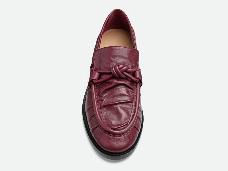 What is the origin of the gathered seam in moccasins?
