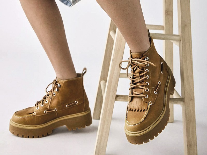 Workwear boots with track soles and visible stitching